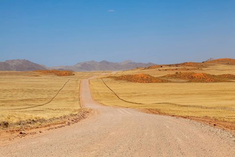 Gravel road C14, in the background the Tiras Mountains, Namibia, Africa