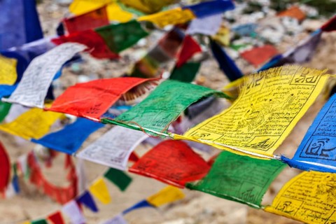 Tibetan Buddhism prayer flags (lungta) with Om Mani Padme Hum Buddhist mantra prayer. Leh, Ladakh,
