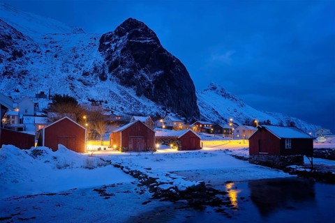 Ramberg village with red traditional rorbue houses in the night. Ramberg, Flakstad, Nordland,
