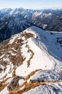 Ski tourers at the summit of Schafreuter, view of snow-covered mountain panorama, Karwendel, Tyrol,