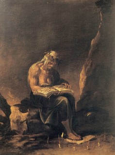 An old witch sits on a rock and reads in a magic book. Around her feet a magic circle of candles,
