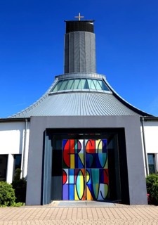 Two-leaf portal designed by Gerhard Böhm and colourful windbreak door made by Peter Luban, St.