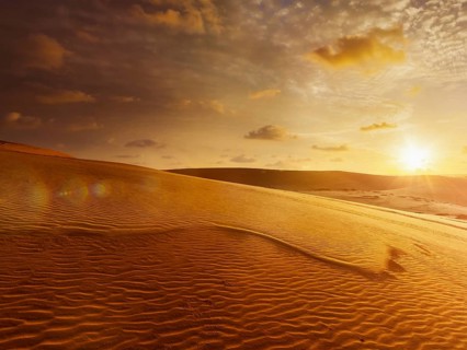 White sand dunes on sunrise, Mui Ne, Vietnam. With lens flare and light leak