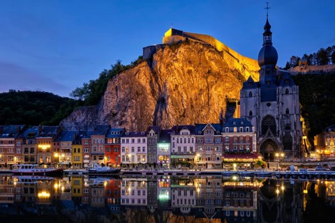 Night view of Dinant town, Collegiate Church of Notre Dame de Dinant over River Meuse and Pont