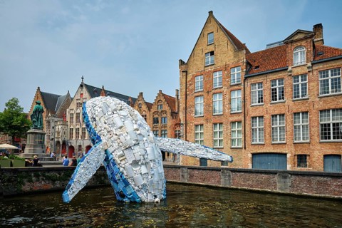 BRUGES, BELGIUM, MAY 29, 2018: Skyscraper or The Bruges Whale, whale rising up from the Canal