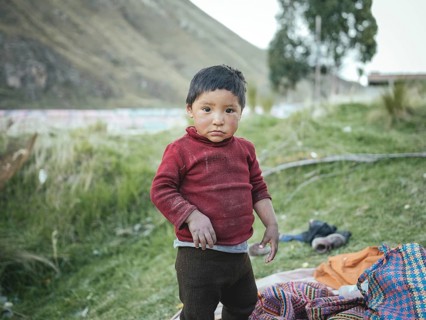 Child of a miner in an open pit kaolin mine, Pachacayo, Peru, South America