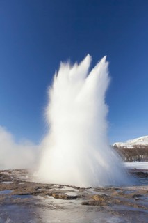 Eruption of Strokkur, fountain geyser in the geothermal area beside the Hvítá River in winter,
