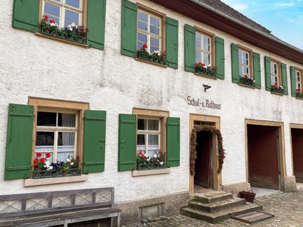 Historic schoolhouse of Bubsheim from 1830 with green shutters rebuilt in the open-air museum