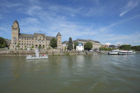 Government building in neo-Romanesque style and gauge house on the banks of the Rhine, quay, pier,