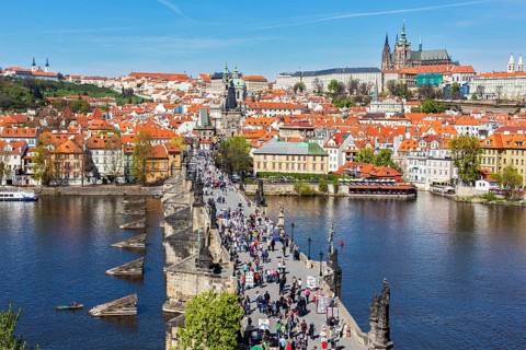 PRAGUE, CZECH REPUBLIC, APRIL 26, 2012: Charles Bridge over Vltava river crowded with tourists in