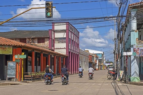 Streetscene showing Bolivians on motorcycles in the colonial city centre of Trinidad in the Amazon,