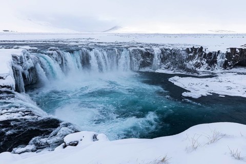 Godafoss waterfall, icy and snowy rock face, snowy landscape, Northern Iceland Eyestra, Iceland,