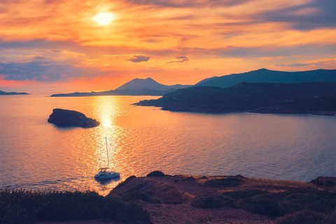 Aegean Sea with Greek islands view on sunset with yacht in sea. Cape Sounion, Greece, Europe