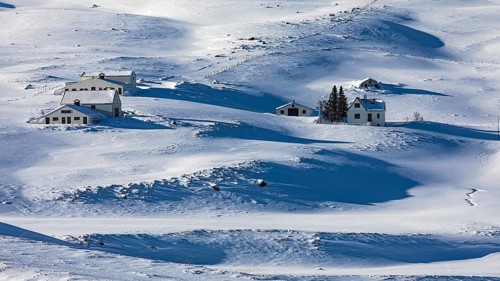 Farmhouse in snow-covered hilly landscape, near Akureyri, North Iceland Eyestra, Iceland, Europe