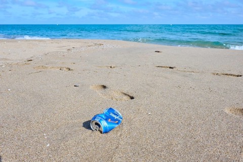 Old can, rubish lying on the sand on a beach, near Tarragona, Catalonia, Spain, Europe