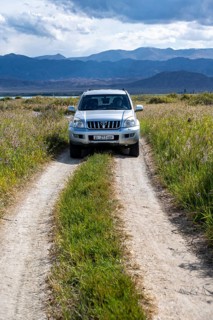 A Toyota Landcruiser off-road vehicle on a dirt track, Yssykköl, Kyrgyzstan, Asia