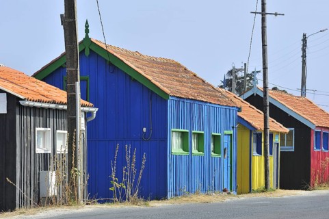 Colourful cabins of oyster farm at la Baudissière near Dolus, Saint-Pierre-d'Oléron on the island