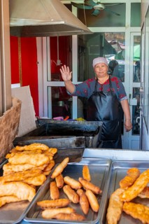 Vendor at the market stall selling pastries, Uzgen Bazaar, Ösgön, Osh region, Kyrgyzstan, Asia