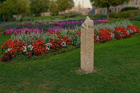 The sculpture Venus of Amberg surrounded by a colourful flower bed in the municipal park, Amberg,