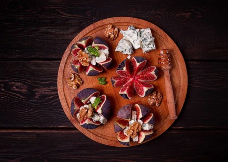 Appetizer, Figs with blue cheese, walnut, honey, on a wooden board, top view, close-up, no people