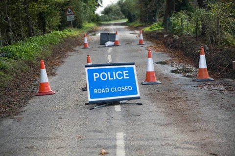 Police Road Closed sign with bollards UK Bawdsey, Suffolk, England, United Kingdom, Europe