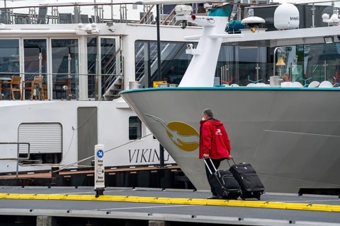 River cruise ships at the quay of the Ij, near the main railway station, passengers' luggage being