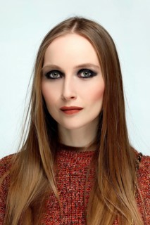 Close up portrait of a girl with provocative evening make up and long hair