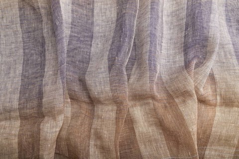 Fragment of brown and violet linen tissue. Top view, natural textile background and texture. wave