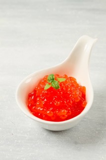 Red caviar, imitation, on a light background, close-up, no people