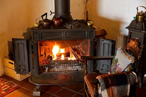 Europe, Germany, fireplace, stove, type Franklin, in living room, chair by the fireplace, Hamburg,
