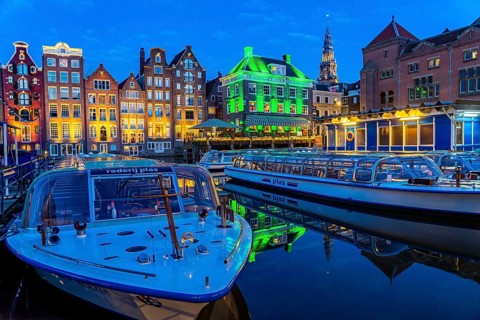 Canal houses on the Damrak, in the centre of the old town of Amsterdam, harbour, starting point of