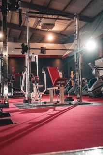 Empty training studio with a red weight bench on a red mat, Historic Fitness Studio, Bulls Fit,