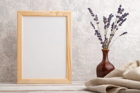 White wooden frame mockup with lavender in ceramic vase and linen textile on gray concrete