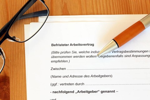 Fixed-term employment contract for blue-collar and white-collar workers on a desk