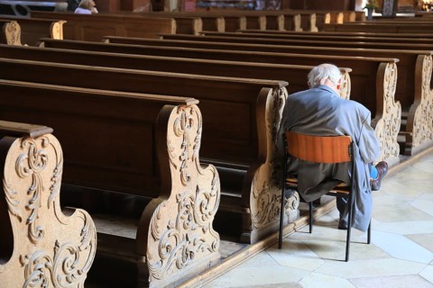 Old grey-haired man as the only churchgoer, interior of the Cistercian Abbey Church Fürstenfeld in