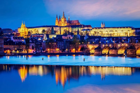 Travel Prague Europe concept background, view of Charles Bridge and Prague Castle in twilight.