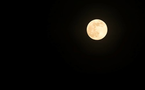 Full moon shortly after moonrise in a black night sky, Lower Saxony, Germany, Europe