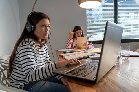 Homeschooling, during the lockdown in January 2021, children learning at home for school, a girl in