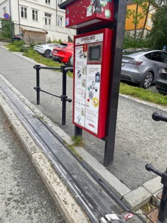 The world's only bicycle lift on a steep street with parked cars and pavement, Nidarelva,