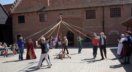 People maypole dancing during Tudor history re-enactment day, Layer Marney Tower, Essex, England,
