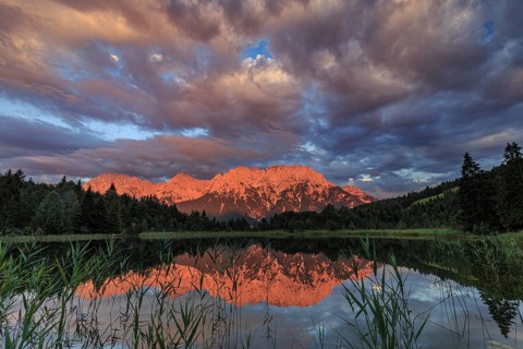 Mountains and clouds reflected in lake, evening light, cloudy mood, summer, Luttensee, Mittenwald,