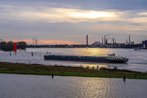 High water on the Rhine near Duisburg, freighter enters the harbour canal, Neuenkamp Rhine bridge,