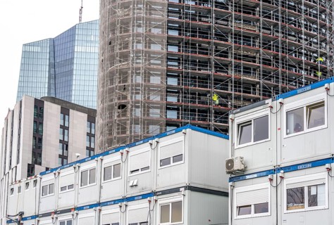 Large construction site, construction of a high-rise residential building, scaffolded shell,
