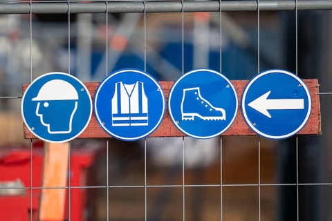 Construction site, safety signs, wear a helmet, high-visibility waistcoat, safety shoes, work