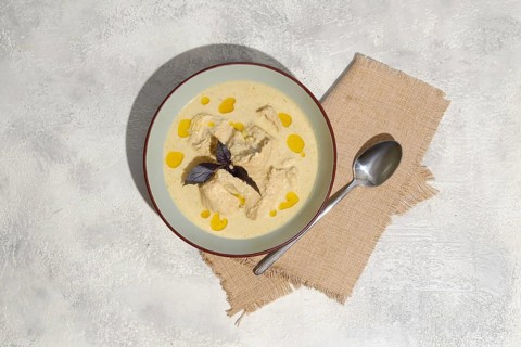 Overhead view of traditional Georgian cold dish satsivi, boiled chicken meat and walnut sauce