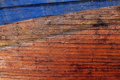 Colourful ship's planks, rotten hull and old planks of a ship, close-up of the underwater hull.