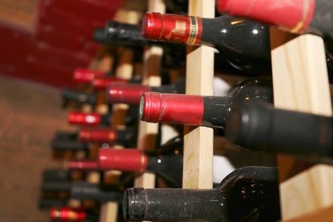Wine cellar with red wine bottles