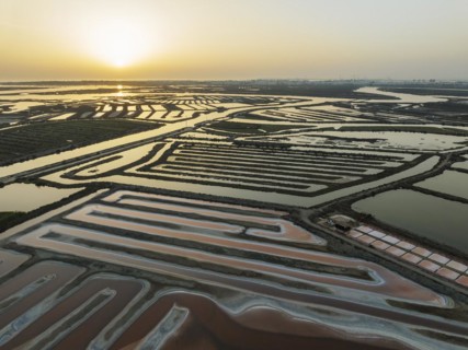 Saline ponds at the salt works near Chiclana de la Frontera. The orange-red colour depends on the