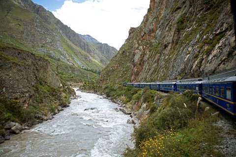 Perurail train travelling through the Andes from Ollantaytambo to Machu Picchu, in front the river