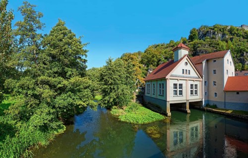 Reflecting Vilsmühle on the idyllic river Vils with surrounding trees, Kallmünz, Upper Palatinate,